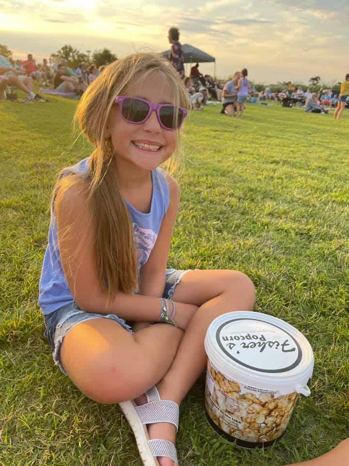 Child enjoying Fishers popcorn at Sundaes in the park