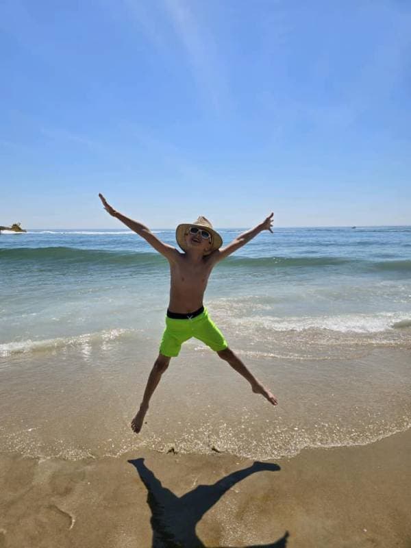 Boy jumping on the Ocean City Md beach
