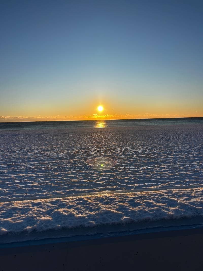 sunrise over snow beach